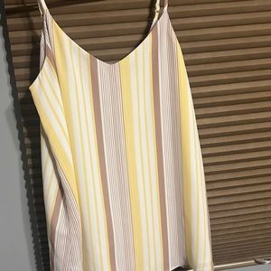 This shirt is a white spaghetti strap tank top with a design.